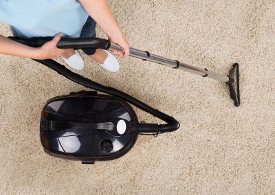 Woman Vacuuming Carpet