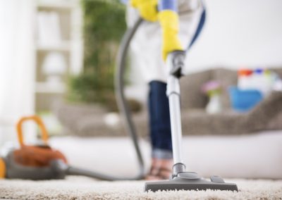 Woman vacuums carpet